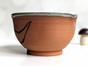 cute otter bowl for matcha in red clay and blue glaze