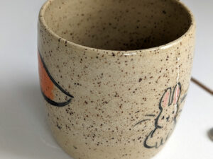 cute cup in speckled clay illustrated with fox and hare - kness