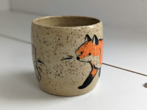 cute cup in speckled clay illustrated with fox and hare - kness