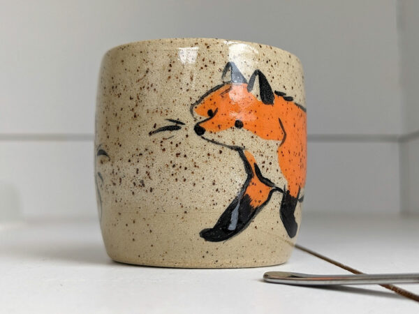 cute cup in speckled clay illustrated with fox and hare - kness