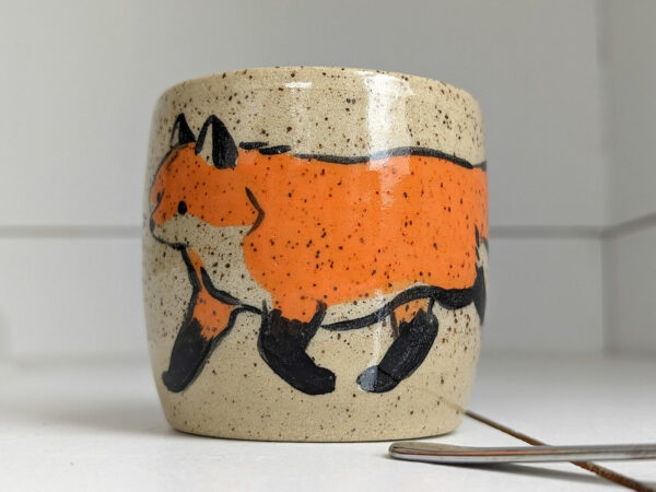 cute cup in speckled clay illustrated with fox and hare - kness