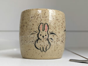 cute cup in speckled clay illustrated with fox and hare - kness