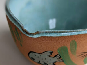 cute otter bowl for matcha in red clay and blue glaze