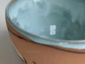 cute otter bowl for matcha in red clay and blue glaze