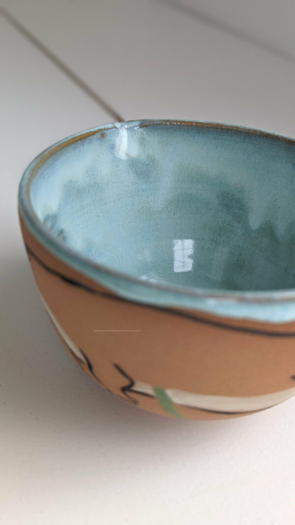 cute otter bowl for matcha in red clay and blue glaze