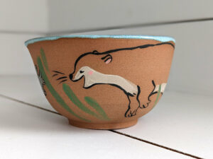 cute otter bowl for matcha in red clay and blue glaze