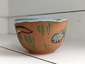 cute otter bowl for matcha in red clay and blue glaze
