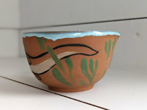 cute otter bowl for matcha in red clay and blue glaze