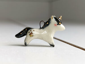 adorable porcelain pendant unicorn with night colored mane and tail, gold, handmade, one of a kind by kness