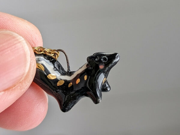 adorable skunk porcelain pendant