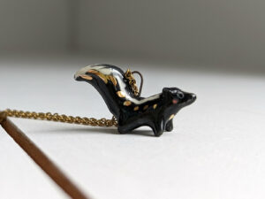 adorable skunk porcelain pendant