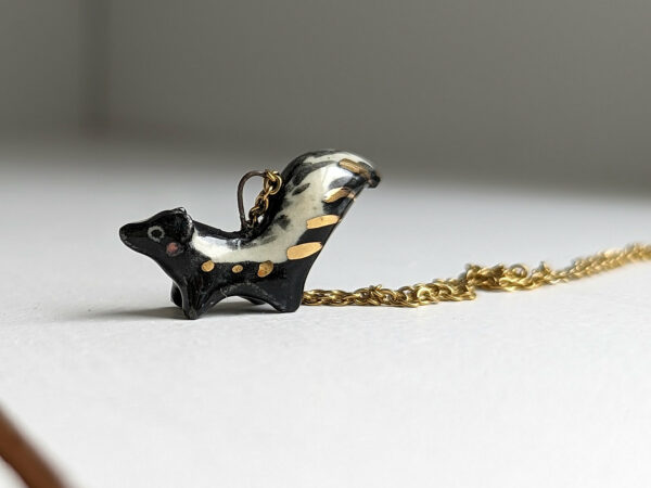 adorable skunk porcelain pendant