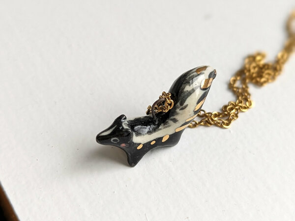 adorable skunk porcelain pendant