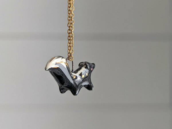 adorable skunk porcelain pendant