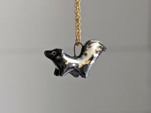 adorable skunk porcelain pendant