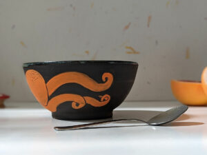 black stoneware handmade orange octopus bowl