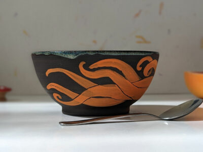 black stoneware handmade orange octopus bowl