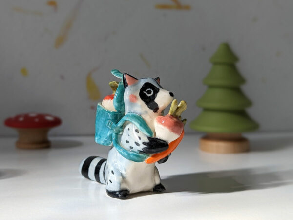 adorable raccoon figurine with a cute backpack porcelain