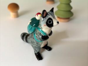 adorable raccoon figurine with a cute backpack porcelain
