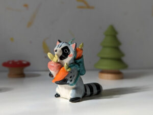 adorable raccoon figurine with a cute backpack porcelain