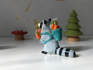 adorable raccoon figurine with a cute backpack porcelain