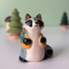 adorable raccoon figurine with a cute backpack porcelain