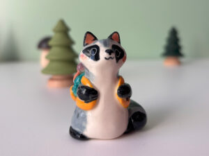 adorable raccoon figurine with a cute backpack porcelain