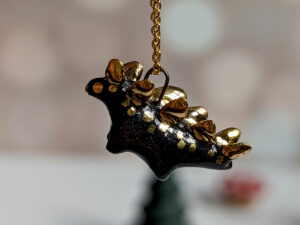 shiny black stegosaurus pendant with gold