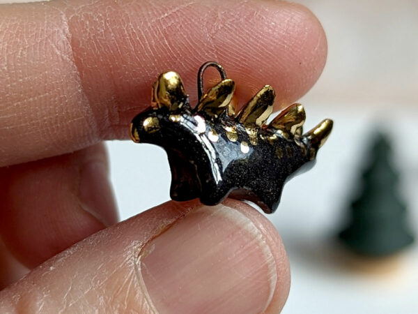 shiny black stegosaurus pendant with gold