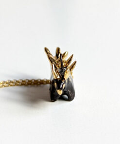 shiny black stegosaurus pendant with gold