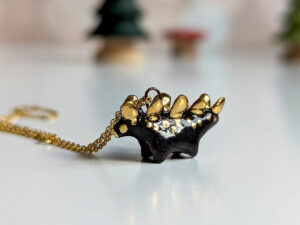 shiny black stegosaurus pendant with gold