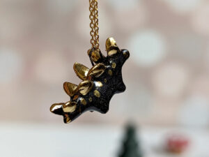 shiny black stegosaurus pendant with gold