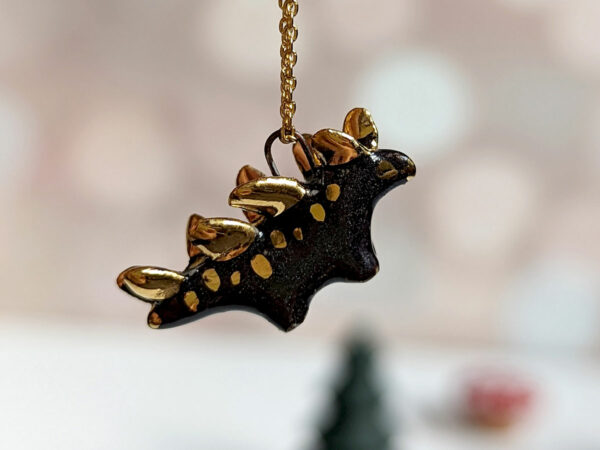 shiny black stegosaurus pendant with gold