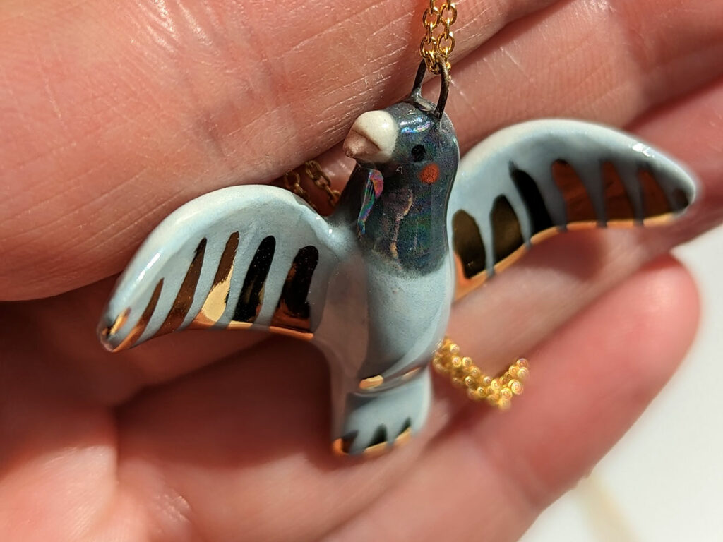 pigeon pendant with gold 
