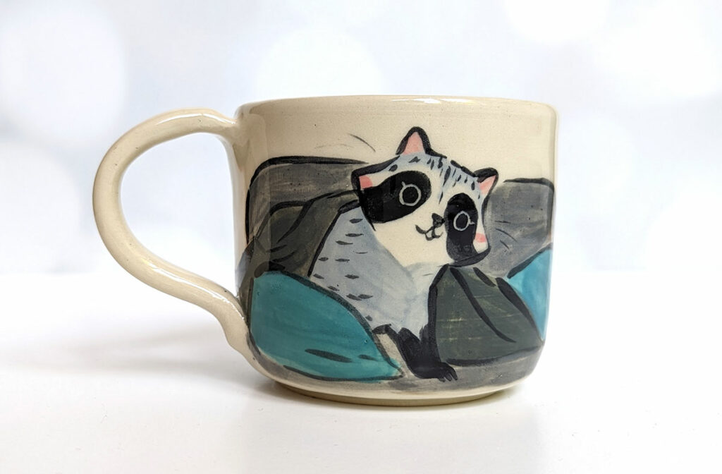 raccoon on the porch mug 