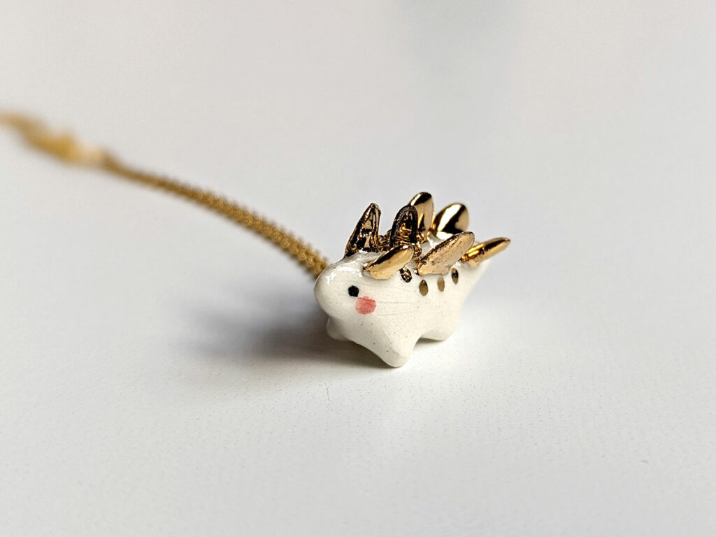 tiny stegosaur pendant 