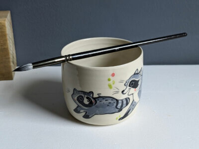 handmade stoneware artist cup for painting raccoons