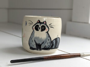 handmade stoneware artist cup for painting raccoons