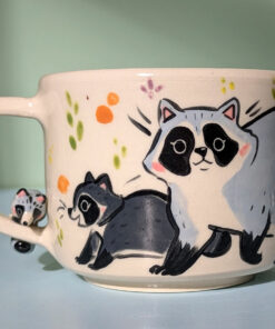 adorable hand sculpted mug with raccoon family