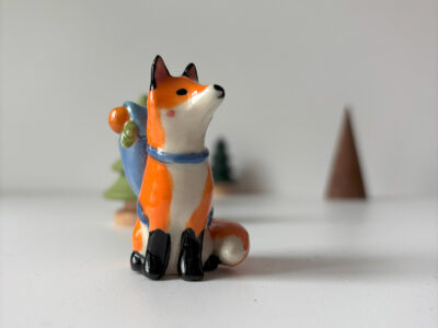 adorable fox figurine with a backpack, handmade porcelain sculpture