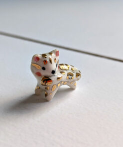 tail in mouth snow leopard pendant with gold