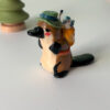 adorable platypus figurine with a backpack and feathered hat