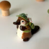 adorable platypus figurine with a backpack and feathered hat