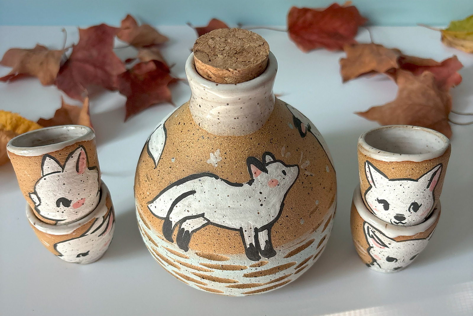 one o fa kind collectible handmade ceramic sake set painted with white foxes