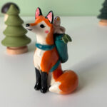 adorable figurine of a fox in a backpack with a passenger handmade in Canada by Kness