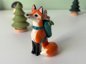 adorable figurine of a fox in a backpack with a passenger handmade in Canada by Kness