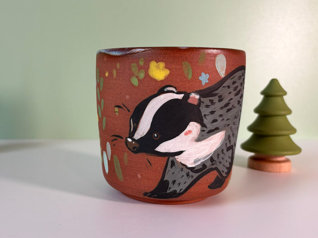 pretty red stoneware cup illustrated with a cute badger handmade in Canada