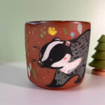 pretty red stoneware cup illustrated with a cute badger handmade in Canada