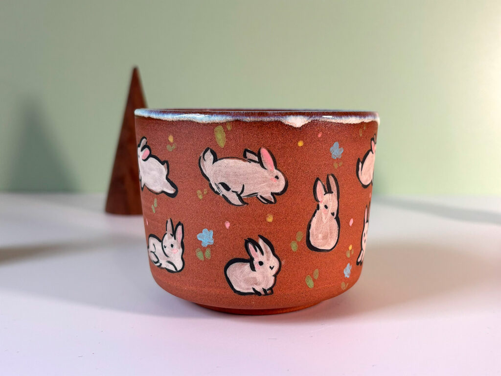 red stoneware cup fluffle of bunnies