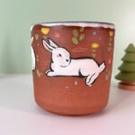 cute red stoneware cup with white bunnies